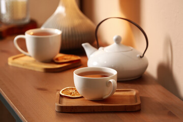 Cups of tasty tea on table in cafe