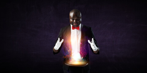 Male illusionist performing tricks . Mixed media