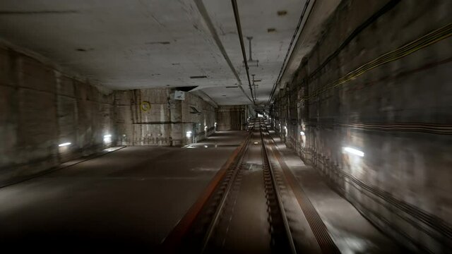 View of subway tunnel from moving underground carriage. Slow motion of riding metro train in metropolitan city. Footage of modern public mode of transport in London