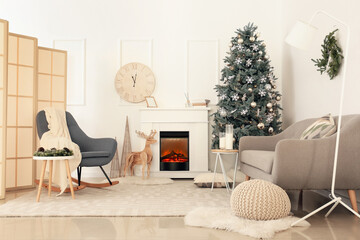 Interior of light living room with Christmas tree near fireplace