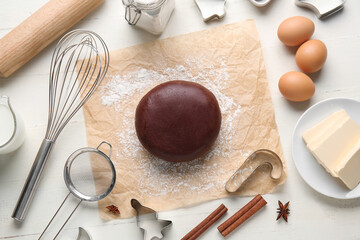 Chocolate dough and ingredients on white wooden background