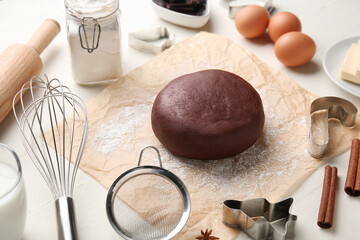 Chocolate dough and ingredients on white wooden background