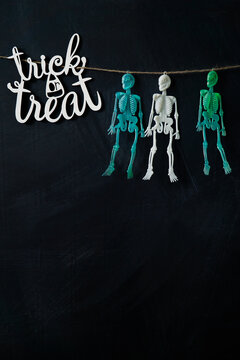    Trick or treat sign colored skeletons hanging