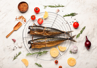 Cooling rack with tasty smoked mackerel on light background