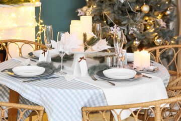 Dining table with beautiful setting in living room decorated for Christmas eve