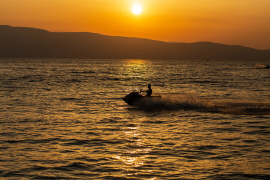 Man on a jet ski at sunset 