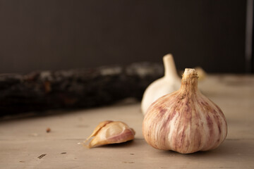 Food photo of raw smoked sausage in a shell on a white vintage table with garlic.