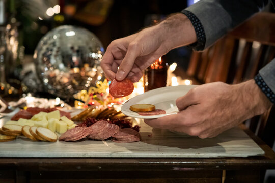 NYE: Anonymous Man Enjoying Meat And Cheese Plate