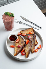Honey and cinnamon french toasts with layered iced coffee on white table in a restaurant, top view