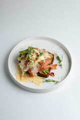 French toast with lettuce and salted salmon, top view on white dish