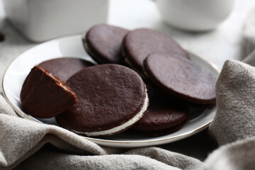 Plate with sweet chocolate cookies on table, closeup