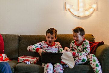 Surprised young brothers opening presents