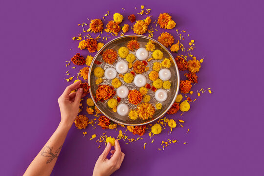 Woman making decoration with flowers and candles