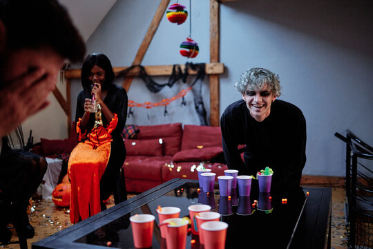 Company of friends having fun during playing board game