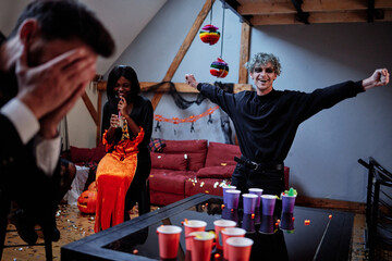Man celebrating his victory in game during  party