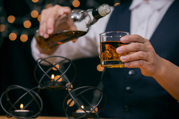 Barman pouring whiskey whiskey glass beautiful night