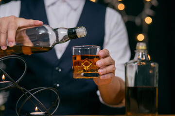 Barman pouring whiskey whiskey glass beautiful night