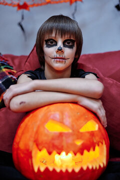 Young boy celebrating Halloween alone at home
