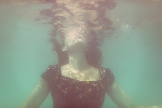 Surreal woman portrait under the ocean
