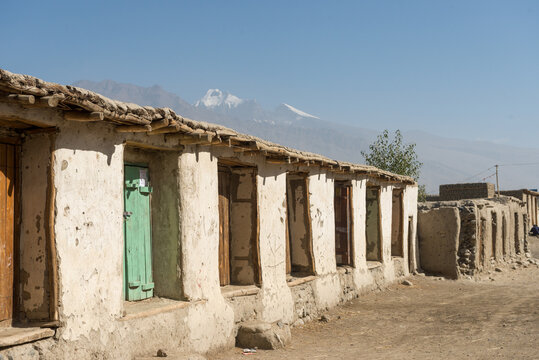 Rustic Buildings With Doorways And Mountains Beyond