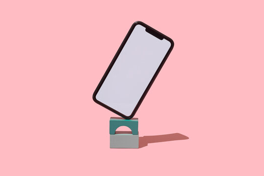 blank smartphone in balance on top of some building blocks