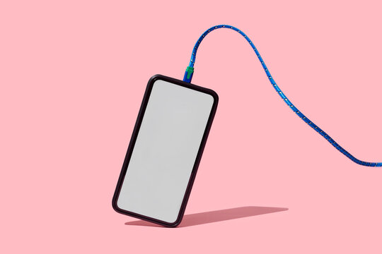 blank smartphone connected to a cable