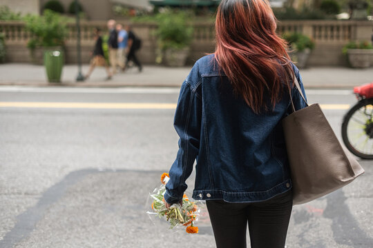 Young woman in busy city street