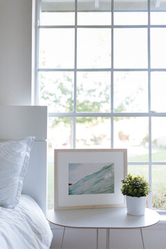 Bright, neutral bedroom with framed art