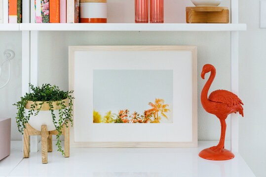White bookshelf with colorful art
