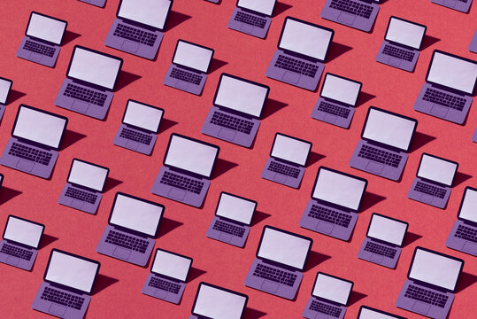 Modern laptops papercraft on pink background