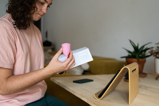 Curiosy teen eading menstrual cup instructions