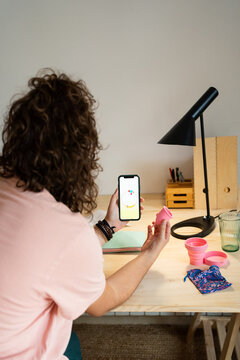 Teen checking her mentrual cycle on smartphone