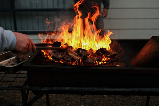 Flame grilled meat on backyard barbecue