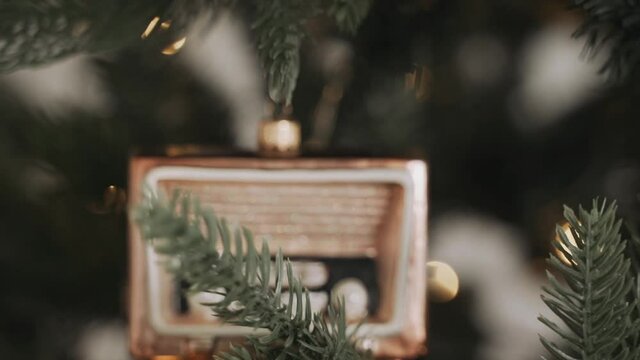 Close-up of woman's hands decorating Christmas tree 