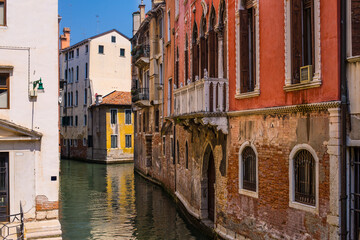 Fototapeta na wymiar Small Venice channels and old facades on a sunny day