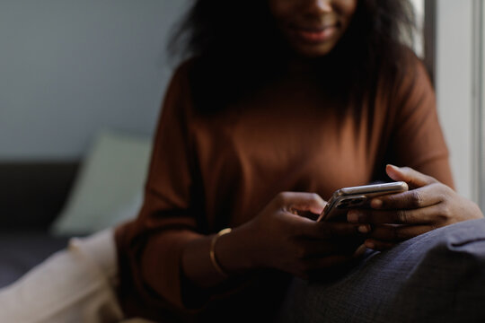 A  woman texting on a mobile phone