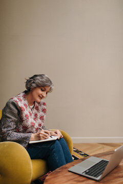 Mature woman studying at home - Online lesson
