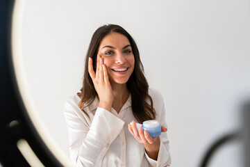 Young woman recording video blog at home