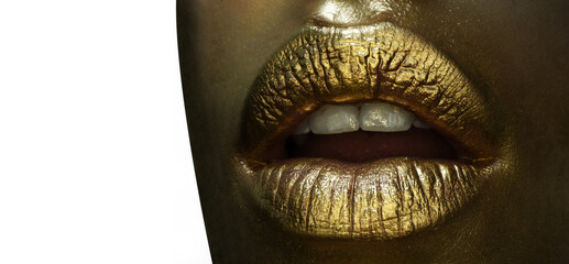 Luxury gold lips make-up. Golden lips with golden lipstick. Gold paint on lips of sexy girl. Sensual woman mouth, isolated background. Glamour golden lips.