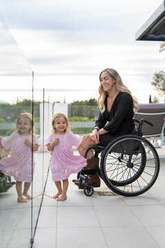 Mother in wheelchair enjoying with her daughter