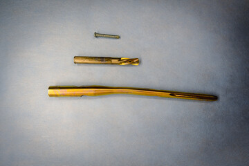 the explanted titanium femoral nail lies cleaned on a light blue support