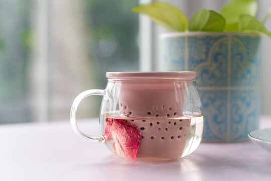 Herbal tea steeping in mug by window