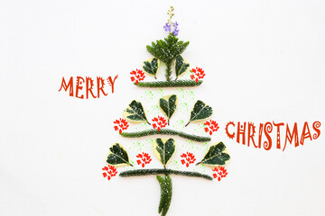 merry christmas message card with flowers arrangement flat lay christmas tree postcard style on background white 