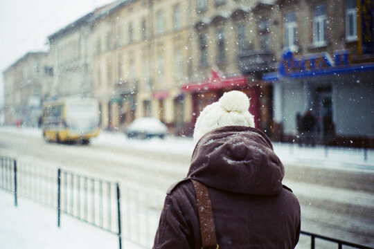 Woman walking on street in winter 
