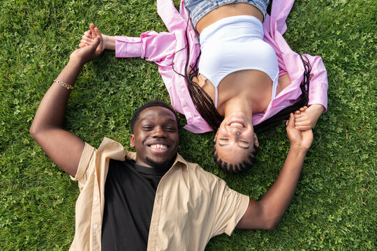 Smiling Couple Laying On The Grass