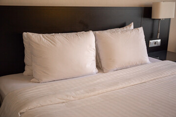 bed in hotel room with pillows