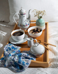 morning meal with coffee and porridge on a tray on the bed