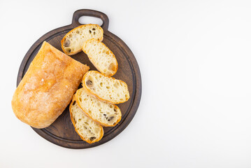 fresh sliced bread on wooden board isolated on a white background
