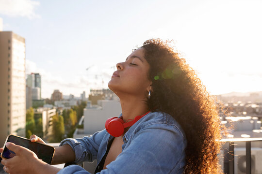Relaxed latin woman on rooftop