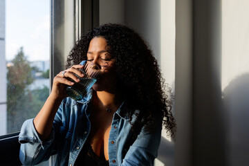 Latin woman drinking water portrait